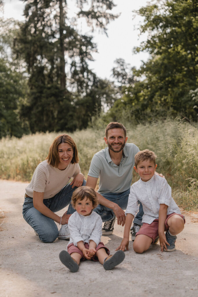 Parents et leurs deux enfants assis ensemble dans un chemin